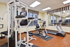 a gym with treadmills and elliptical machines at Country Inn & Suites by Radisson, Wilson, NC in Wilson