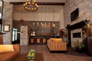 a living room with a couch and a fireplace at Park Inn by Radisson Salt Lake City -Midvale in Midvale