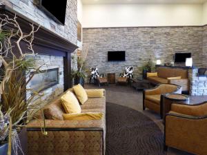 a lobby with a couch and a fireplace at Park Inn by Radisson Salt Lake City -Midvale in Midvale