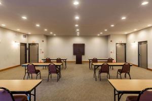 a room with tables and chairs in a room at Country Inn & Suites by Radisson, El Dorado, AR in El Dorado