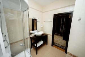 a bathroom with a sink and a shower at Hotel Florence in Chişinău +25 photos