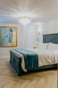 a bedroom with a large bed and a chandelier at The Lighthouse Boutique Hotel in Port Isabel