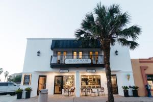 a palm tree sitting in front of a store at The Lighthouse Boutique Hotel in Port Isabel