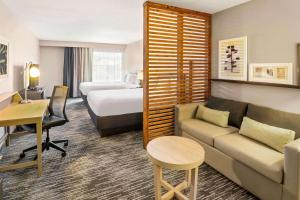 a hotel room with a couch and a bed at Country Inn & Suites by Radisson, Flagstaff Downtown, AZ in Flagstaff +41 photos