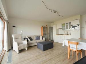 a living room with a couch and a table at West31 with beautiful sea views in Oostduinkerke