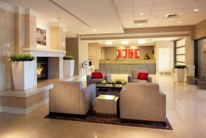 a lobby with chairs and a fireplace in a hospital at Radisson Hotel Phoenix Airport in Phoenix