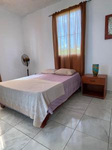 a bedroom with a bed and a window at Casa refugio in Las Galeras