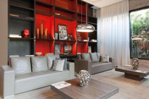 una sala de estar con 2 sofás y una pared roja. en Radisson Blu Belo Horizonte Savassi, en Belo Horizonte