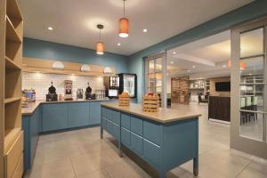 a large kitchen with blue walls and a counter at Country Inn & Suites by Radisson, Page, AZ in Page