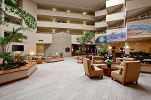 a lobby of a hotel with chairs and tables at Radisson Hotel Santa Maria in Santa Maria