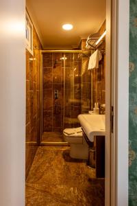 a bathroom with a shower and a toilet and a sink at Golden Dream Otel in Istanbul