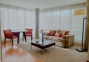 a living room with a couch and a table at Faranda Collection Bogota, a member of Radisson Individuals in Bogotá