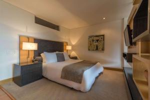 a bedroom with a large bed and a television at Faranda Collection Bogota, a member of Radisson Individuals in Bogotá