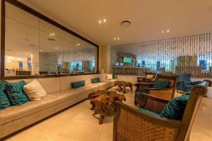a lobby with a couch and chairs and a bar at Radisson Cartagena Ocean Pavillion Hotel in Cartagena de Indias