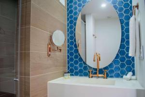 a bathroom with a sink and a mirror at Faranda Collection Cali, a member of Radisson Individuals in Cali