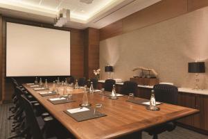 a large conference room with a long table and chairs at Radisson Hotel & Conference Centre Calgary Airport in Calgary