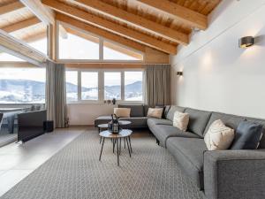 a living room with a couch and a table at Grebenzen Top Chalet Mazzel in Sankt Lambrecht