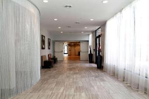 a hallway with white curtains and a long hallway at Plaza Hotel Denver Central in Denver +23 photos