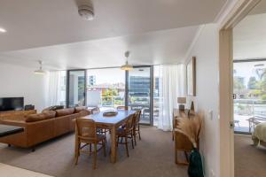 a living room with a table and a couch at 'Sage' at The Crest - Spacious ground floor apartment in Forster