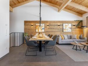 a dining room with a table and chairs and a couch at Alpenchalet Lambert in Sankt Lambrecht