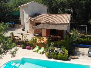 a small house with a swimming pool in the yard at Stylish holiday home near St Br s in Saint-Brès