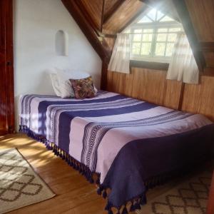 1 dormitorio con 2 camas y ventana en Cabañita con cocineta y vista a la montaña, en San Pablo Etla