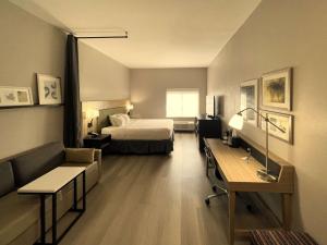 a hotel room with a bed and a desk at Country Inn & Suites by Radisson, Midway - Tallahassee West in Midway +15 photos