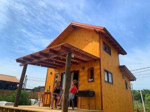 a house with people standing outside of it at Nao Tem Fim in Punta Del Diablo