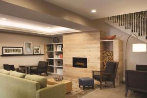 a living room with a couch and a fireplace at Country Inn & Suites by Radisson, Atlanta Airport North, GA in Atlanta