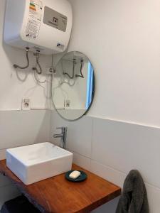 a bathroom with a white sink and a mirror at Morada Montevideana in Montevideo