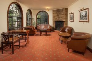 a waiting room with leather furniture and a fireplace at Fairview Hotel Nairobi in Nairobi