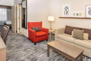 a living room with a couch and a chair at Country Inn & Suites by Radisson, Smyrna, GA in Smyrna