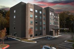 a building with a parking lot in front of it at Country Inn & Suites by Radisson, Cumming, GA in Cumming