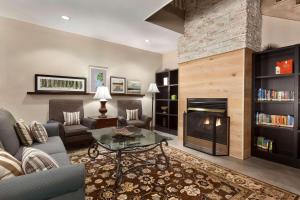 a living room with a fireplace and a couch at Country Inn & Suites by Radisson, Dalton, GA in Dalton