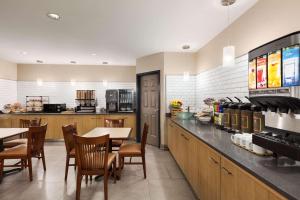 a restaurant with a table and chairs and a kitchen at Country Inn & Suites by Radisson, Dalton, GA in Dalton