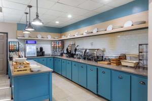 a large kitchen with blue cabinets and appliances at Country Inn & Suites Atlanta Downtown in Atlanta