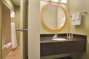 a bathroom with a sink and a mirror at Park Inn by Radisson Albany in Albany