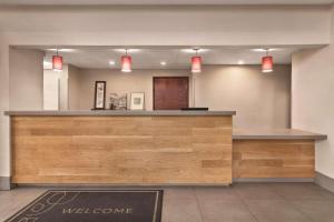 a welcome counter in a hotel lobby with red lights at Country Inn & Suites by Radisson, Griffin, GA in Griffin