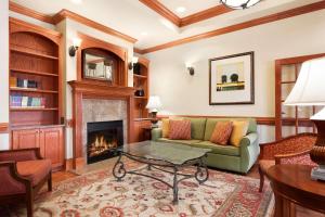 a living room with a couch and a fireplace at Country Inn & Suites by Radisson, Tifton, GA in Tifton