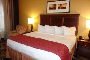 a hotel room with a large bed and a chair at Country Inn & Suites by Radisson, Helen, GA in Helen