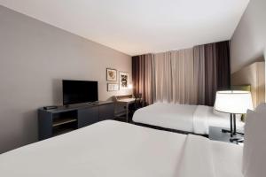 a hotel room with two beds and a flat screen tv at Country Inn & Suites by Radisson, Augusta at I-20, GA in Augusta +30 photos