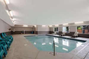 a large swimming pool with blue chairs in a building at Country Inn & Suites by Radisson, Augusta at I-20, GA in Augusta