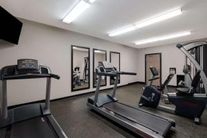 a gym with treadmills and ellipticals in a room at Country Inn & Suites by Radisson, Augusta at I-20, GA in Augusta