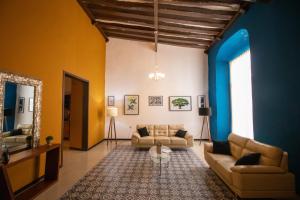 a living room with two couches and a table at Viveza - Downtown in Campeche