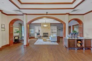 a living room with an archway and a living room at Country Inn & Suites by Radisson, Braselton, GA in Braselton