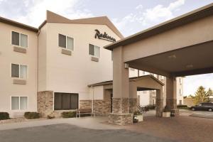 a hotel building with a car parked in front of it at Radisson Hotel Ames Conference Center at ISU in Ames