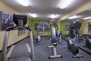 a gym with several tread machines in a room at Country Inn & Suites by Radisson, Mason City, IA in Mason City