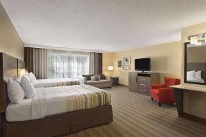 a hotel room with a bed and a television at Country Inn & Suites by Radisson, Ankeny, IA in Ankeny