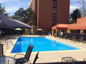 a large swimming pool with chairs and a building at Radisson Hotel Schaumburg in Schaumburg