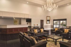 a large waiting room with couches and a bar at Radisson Hotel & Conference Center Rockford in Rockford